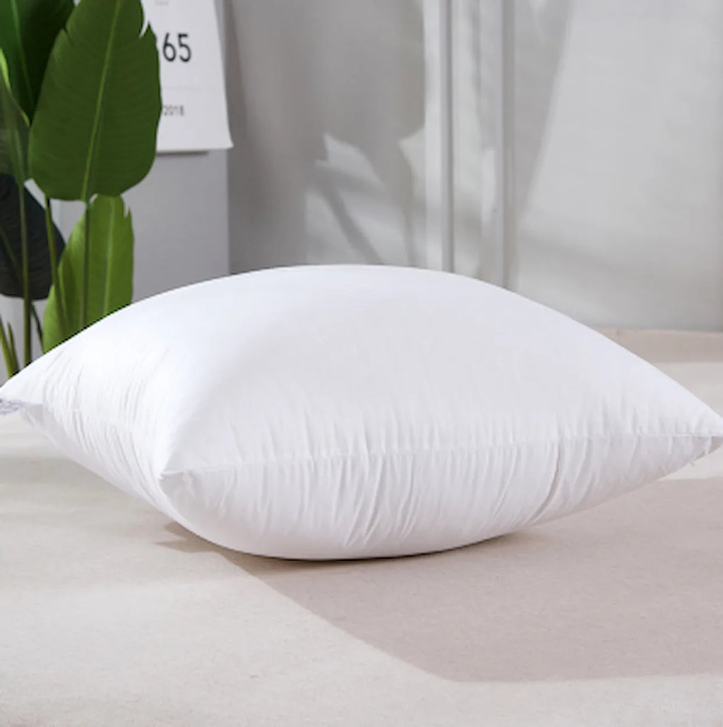 White pillow on a light surface with a neutral background