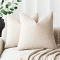 Beige pillows on a sofa with a neutral background
