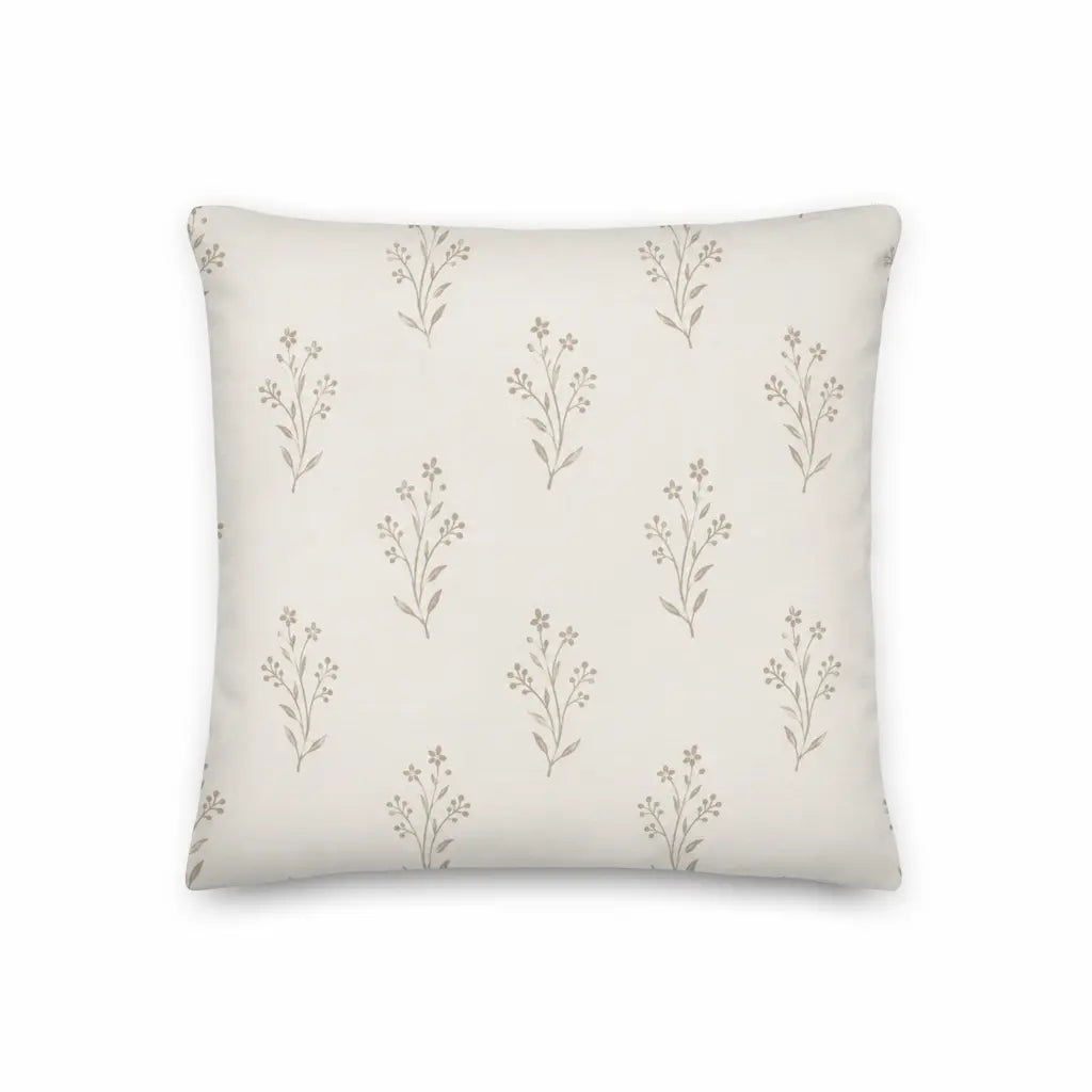 Decorative pillow with subtle floral pattern on a plain background